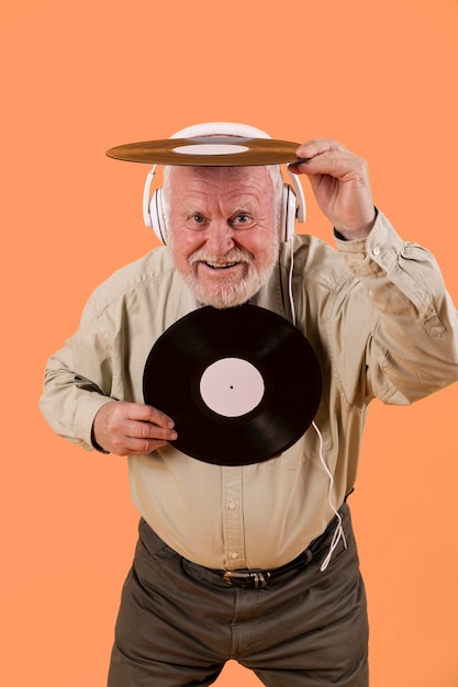 High angle smiley senior playing with music records