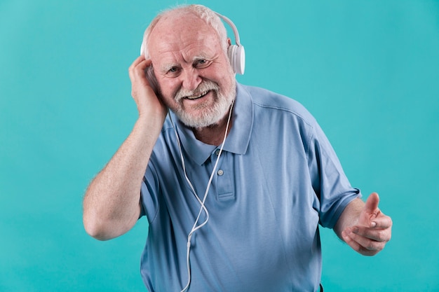 High angle smiley senior with headphones