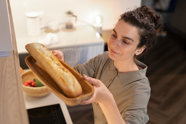 High angle smiley woman holding bread