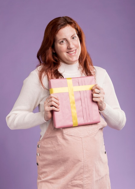 Free photo high angle smiley woman holding gift