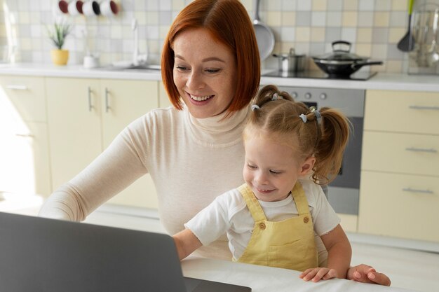 high angle smiley woman holding girl