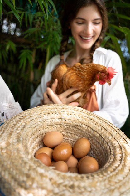 High angle smiley woman holding hen