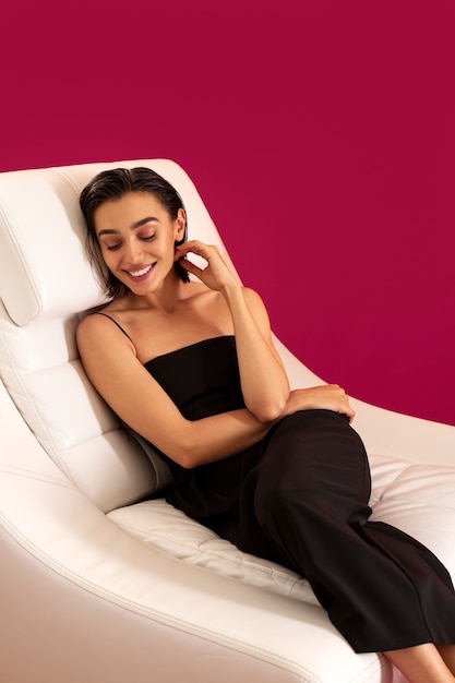 High angle smiley woman laying on chair