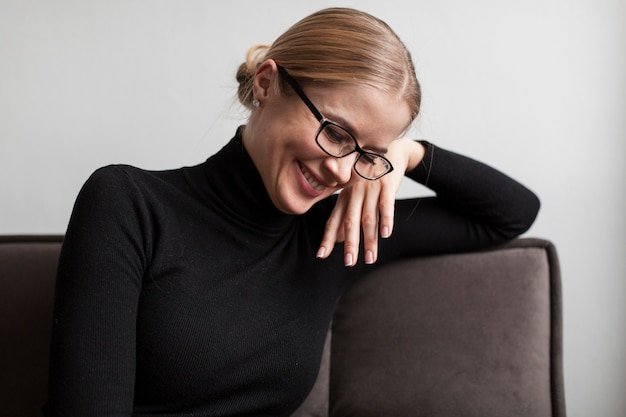 High angle smiley woman sitting on couch