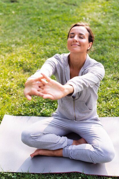 High angle smiley woman stretching