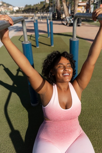 High angle smiley woman training outdoors