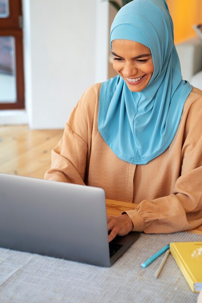 High angle smiley woman wearing hijab