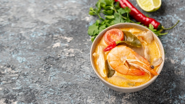 High angle soups in bowls with shrimp lemon and pepper with copy space