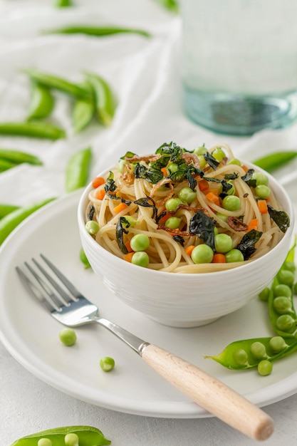 High angle spaghetti wti peas and veggies