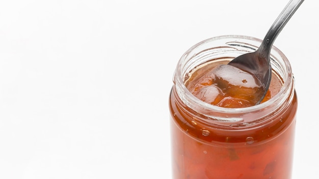 High angle spoon in jam jar