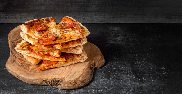 High angle stack of pizzas with copy-space