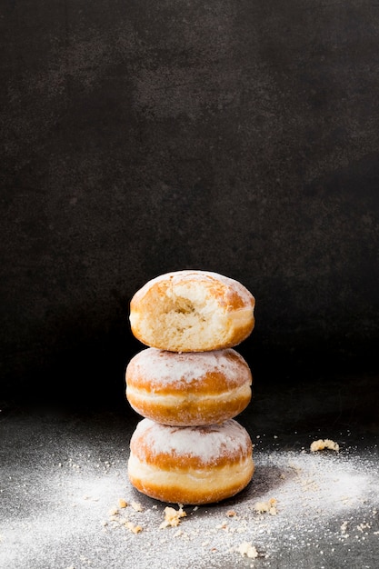 High angle of stacked donuts with powdered sugar