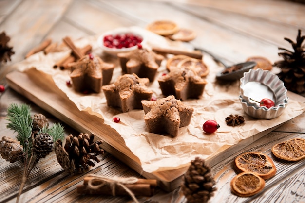 High angle of star-shaped cookies with pine cones