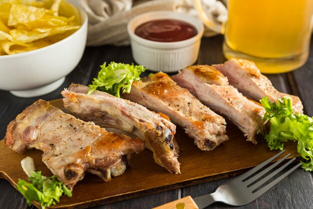 High angle of steak with beer and chips