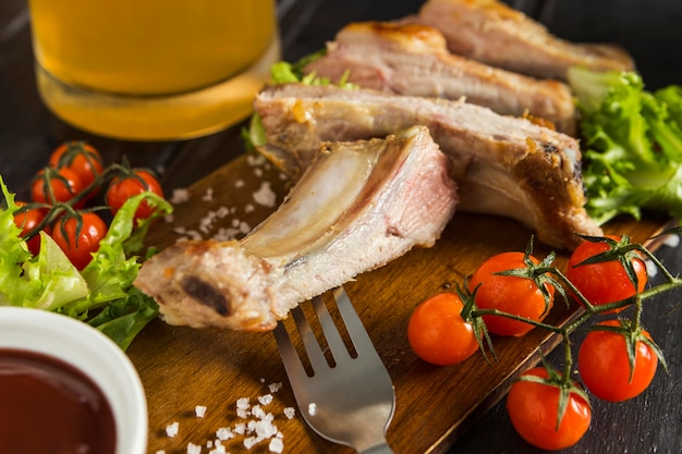 High angle of steak with tomatoes and beer