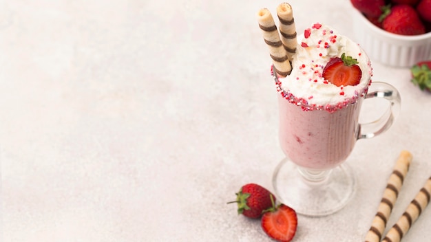 High angle of strawberry milkshake with copy space