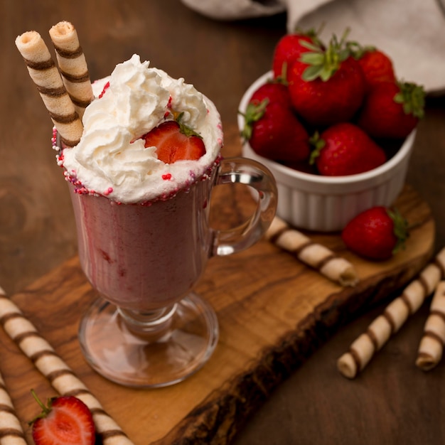 High angle of strawberry milkshake with cream