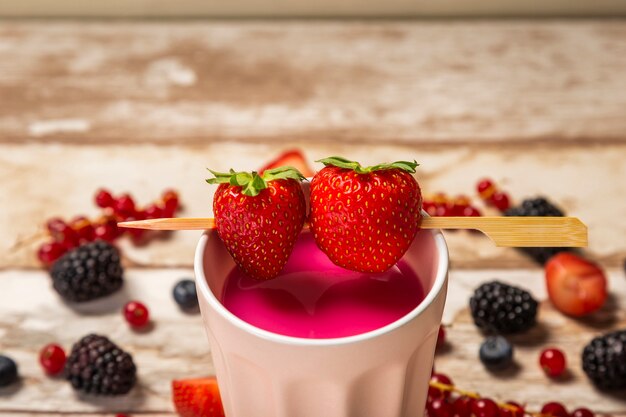 High angle strawberry smoothie in cup close-up