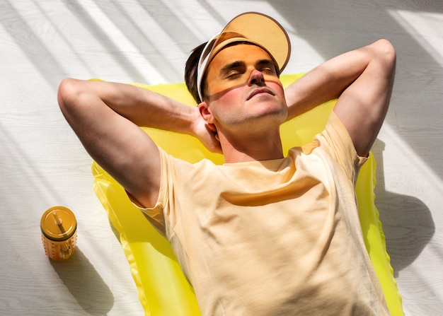 Free photo high angle sunburned man posing in studio