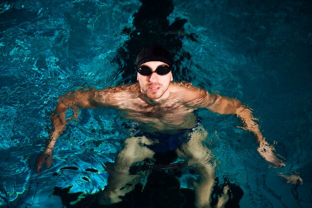 High angle swimming man in basin