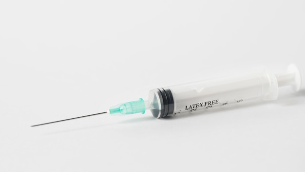 High angle syringe on white background