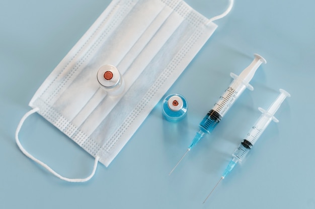 Free photo high angle of syringes and medical mask with iv's