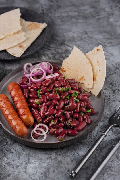 High angle tasty beans dish with sausages