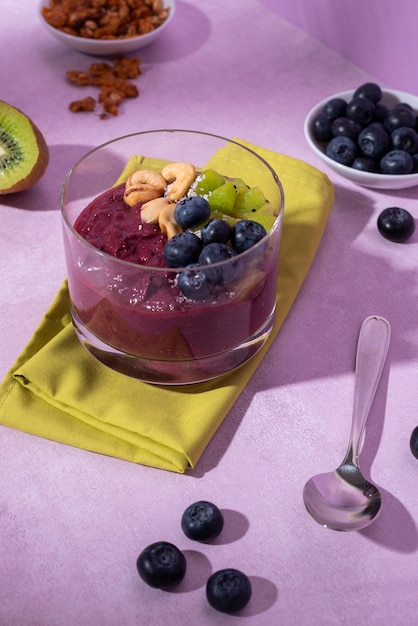 high angle tasty cup of açai dessert with berries