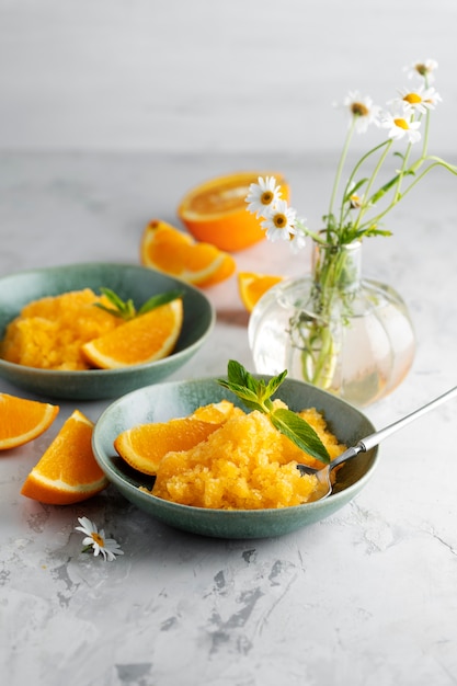 High angle tasty granita dessert with orange still life