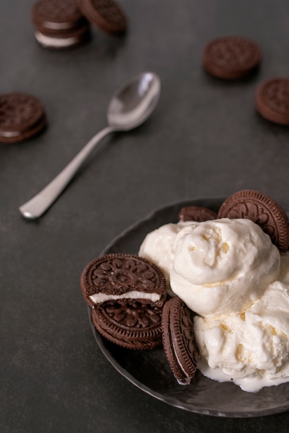 Free photo high angle tasty ice cream and cookies on table