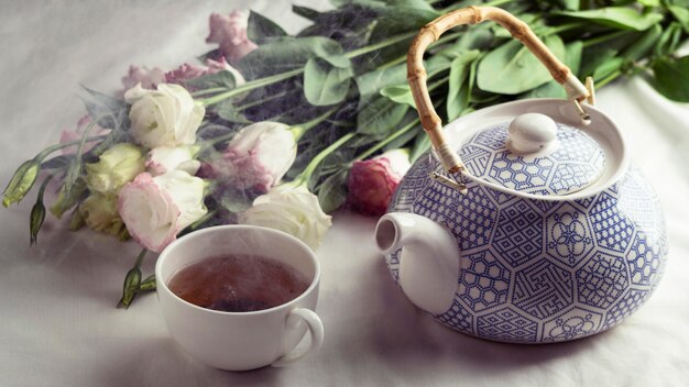 High angle tea cup and flowers arrangement