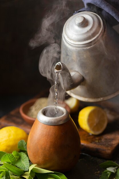 High angle teapot pouring hot water in infuser