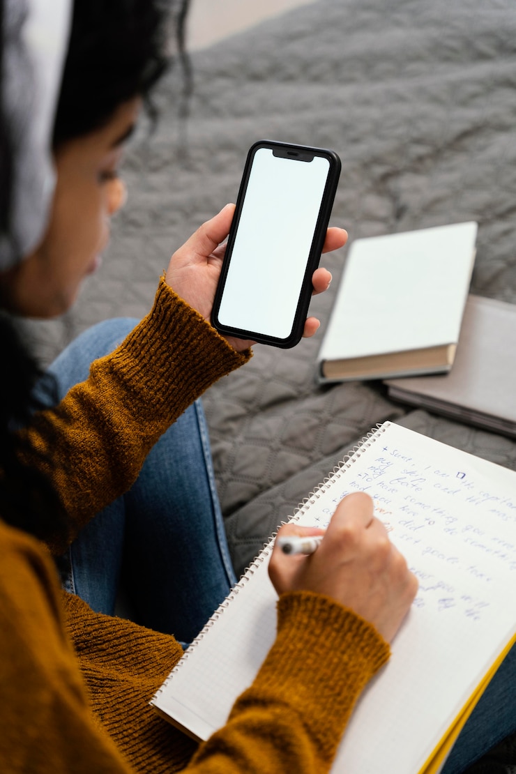 Free Photo high angle of teenage girl using smartphone for online school