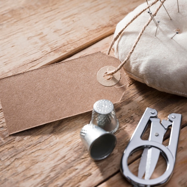 High angle of thimbles with scissors and tag