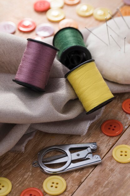 High angle of thread reels with textile and buttons