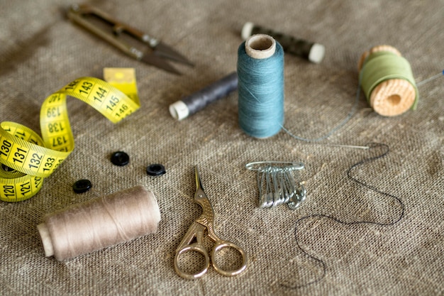 Free photo high angle of thread rolls and scissors