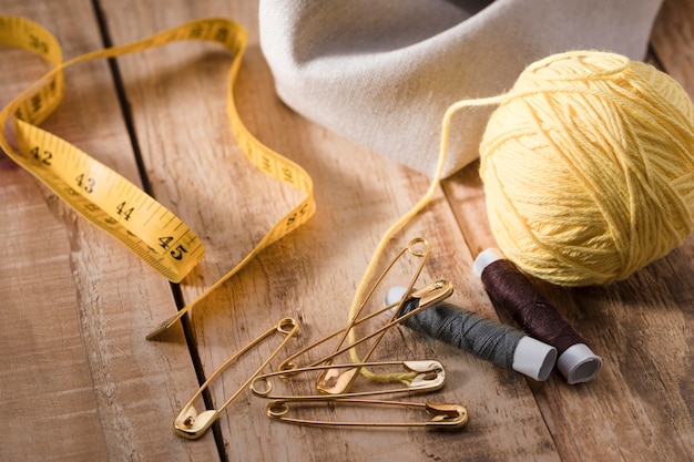 High angle of thread with safety pins and measuring tape