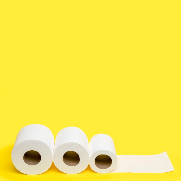 High angle of three toilet paper rolls with copy space