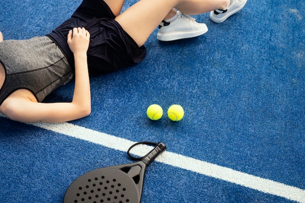 Free photo high angle tired woman laying on ground