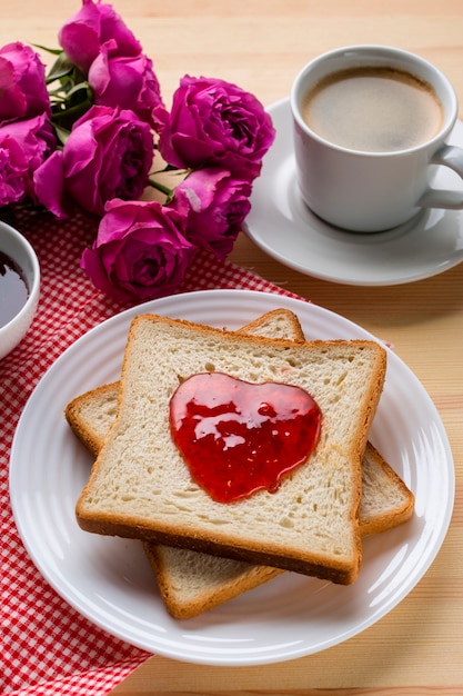 High angle of toast with jam and coffee