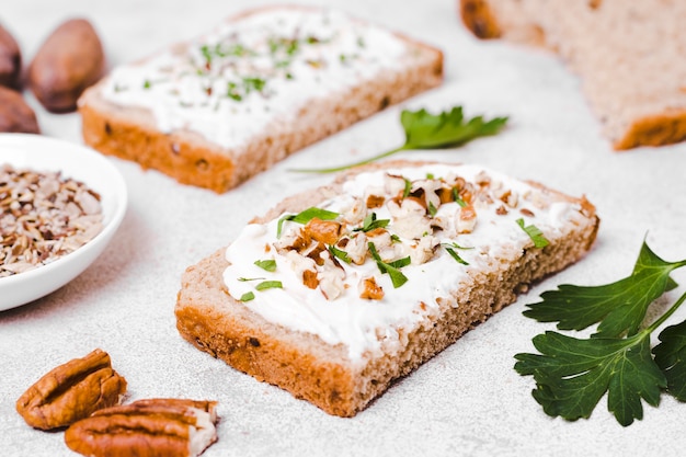 High angle of toast with spread and walnuts