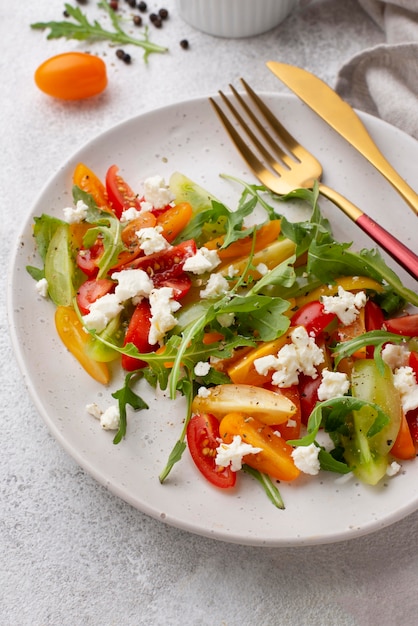 High angle tomato salad with feta cheese and cutlery