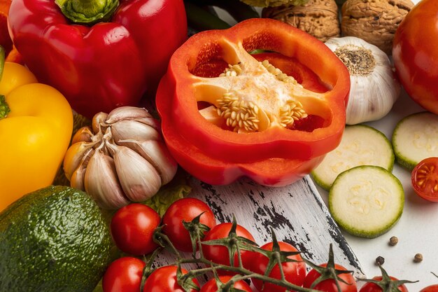 High angle of tomatoes with bell pepper and garlic