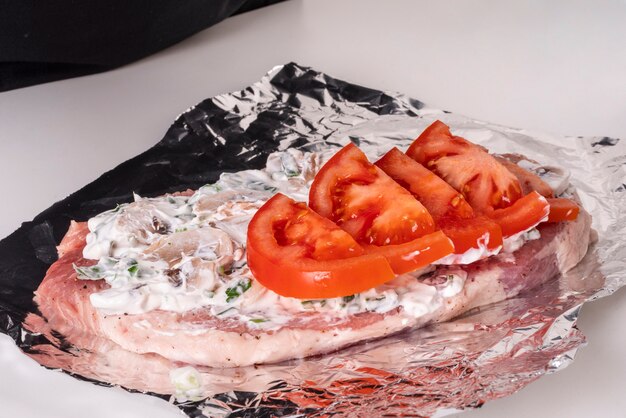 High angle of tomatoes with mushroom sauce on top of meat