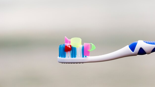 High angle toothbrush with plastic pieces