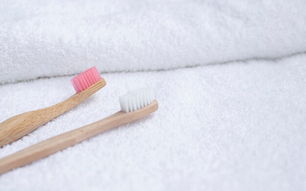 High angle toothbrushes on white towel