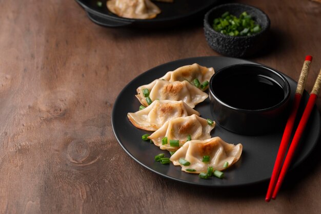 High angle of traditional asian dish with chopsticks and herbs