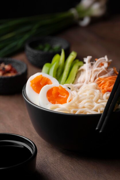 High angle of traditional asian dish with eggs in noodles