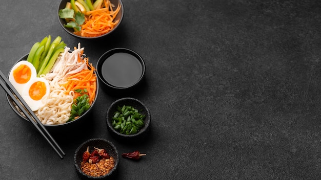 High angle of traditional asian noodles with vegetables and copy space