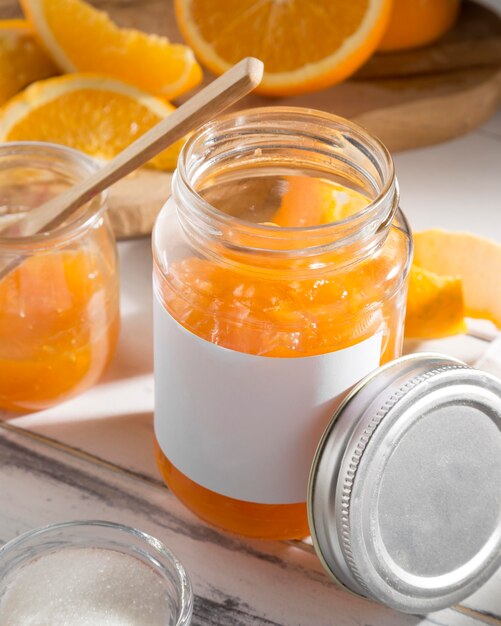 High angle of transparent glass jar with orange jam